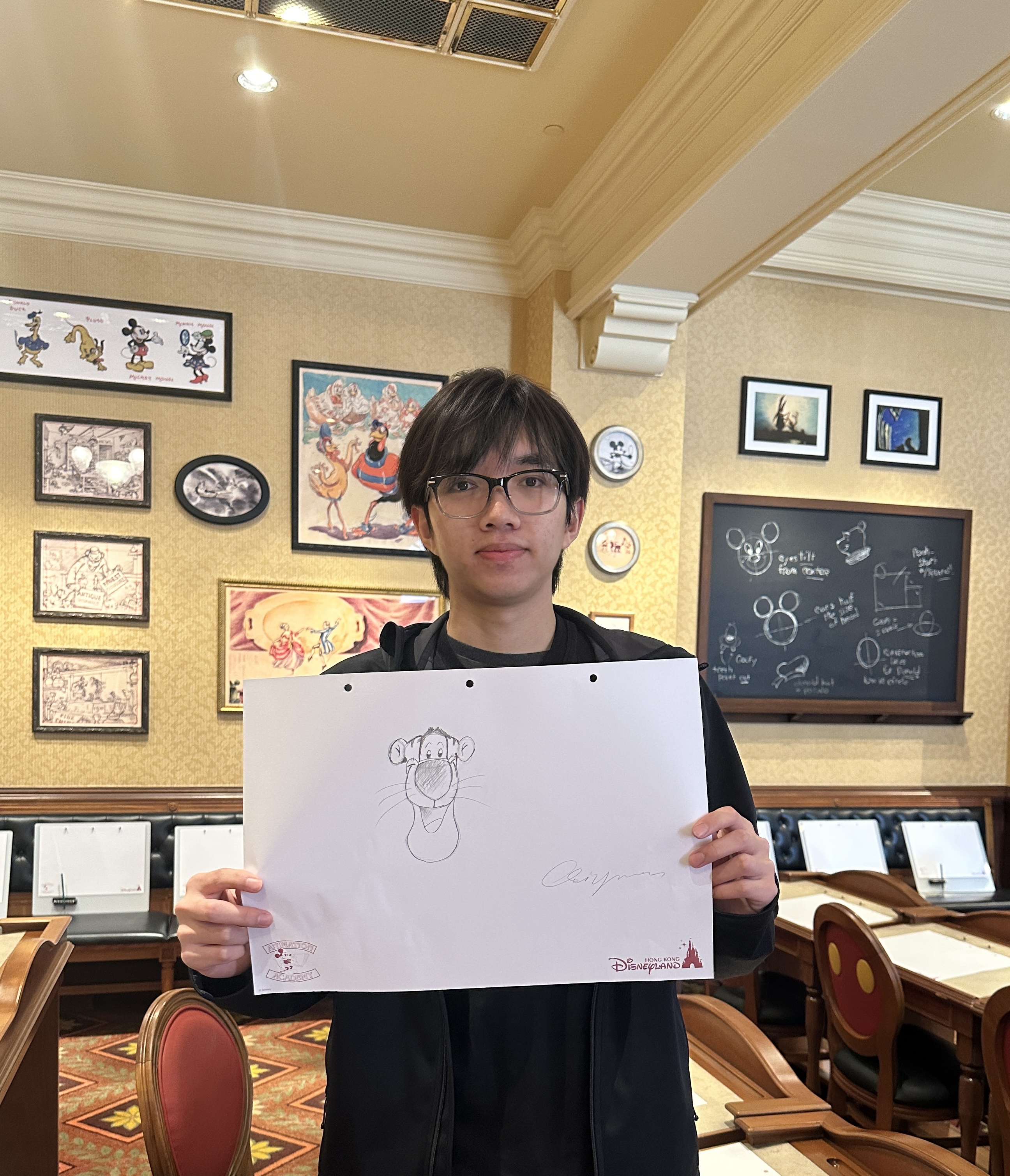Qiyuan Zhuang holding a hand-drawn portrait of Tigger